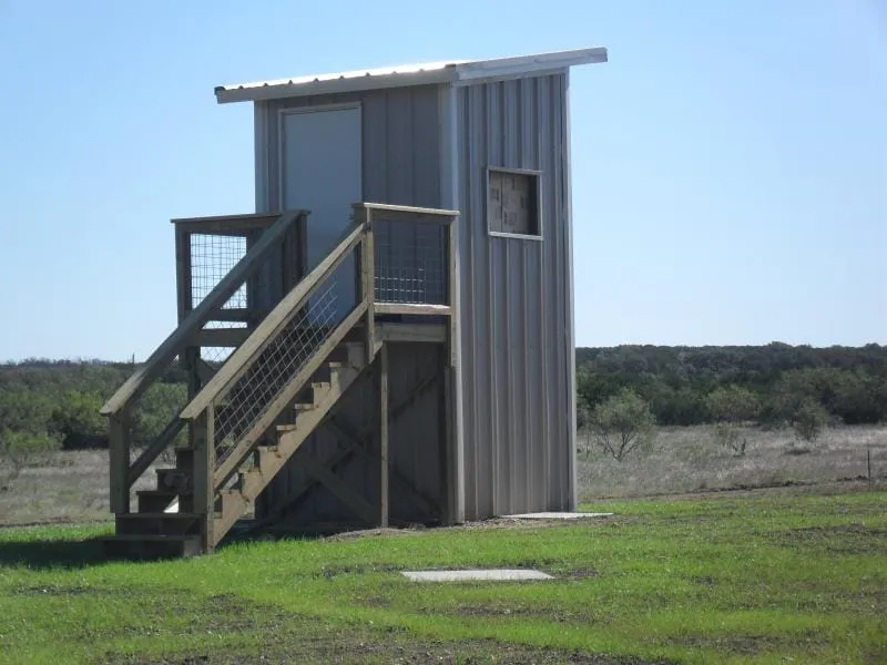 Elevated steel deer blind with stairway and viewing windows.