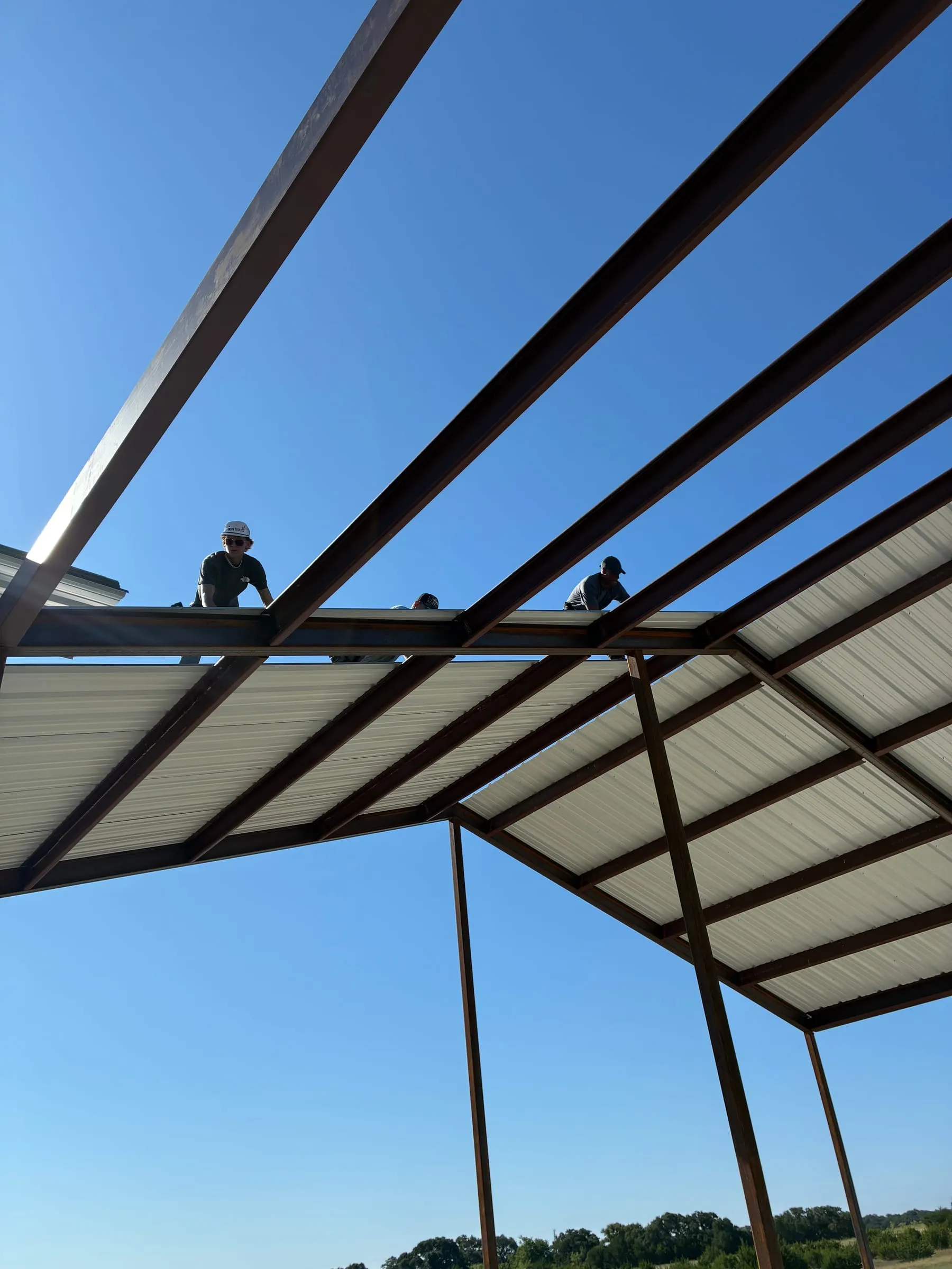 Metal roof panels secured across the shop extension's steel frame.
