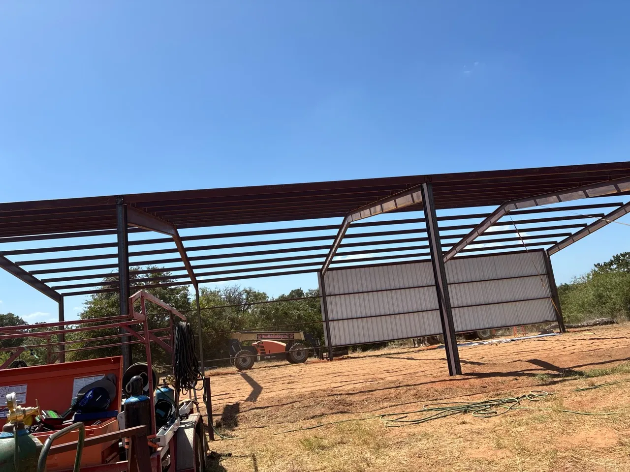 Steel frame and roof installation progressing on the Whitney hay barn.