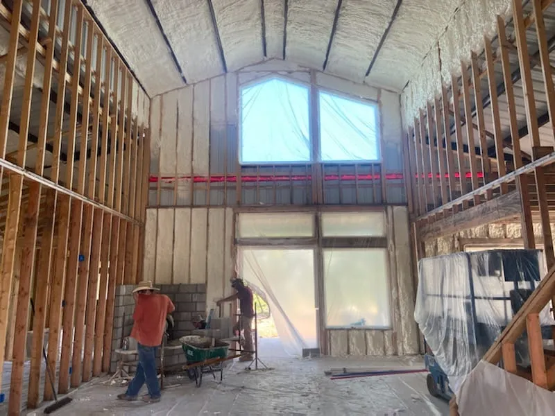 Interior framing and window install in the vaulted great room.