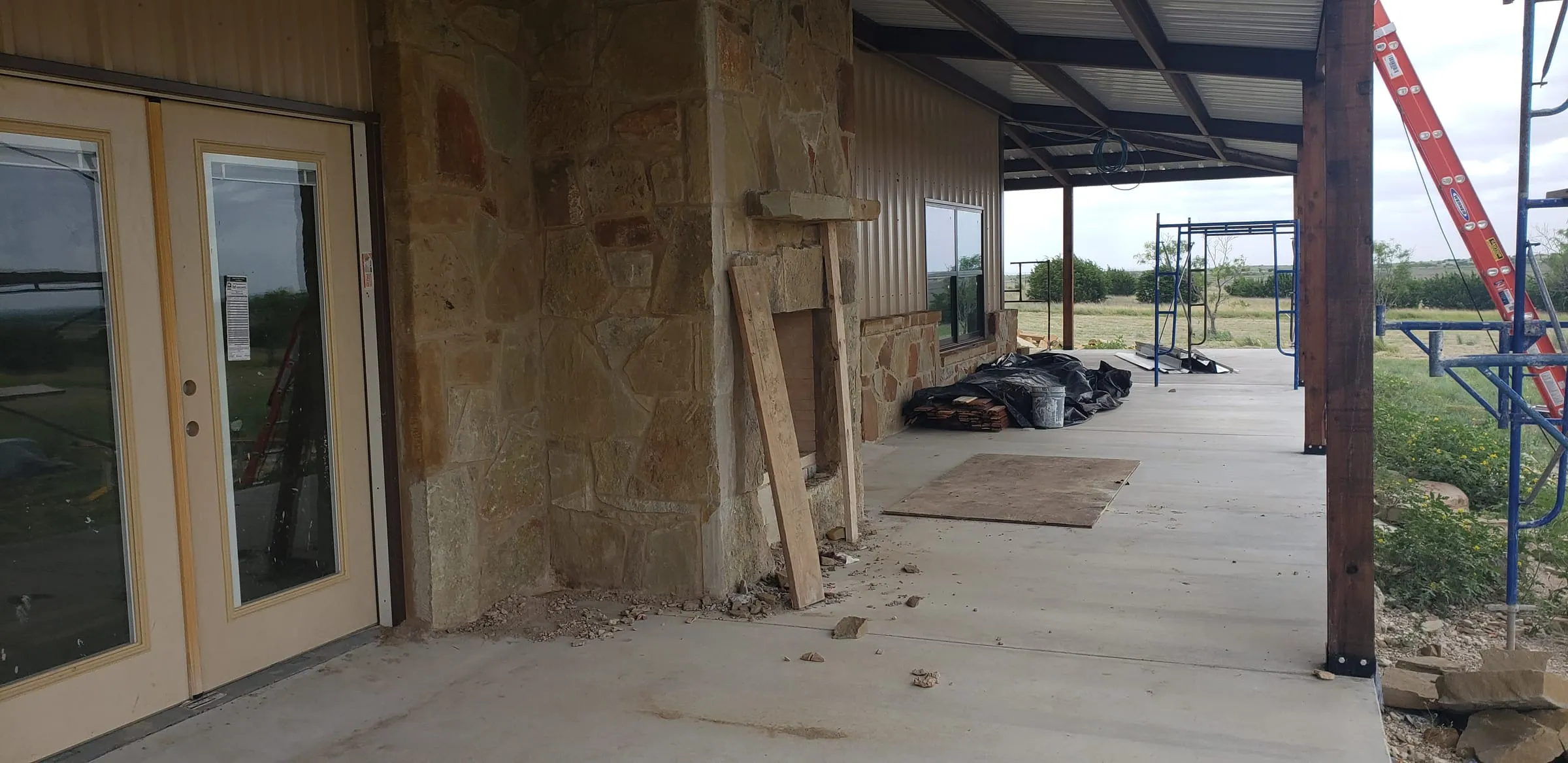 Floor-to-ceiling stone fireplace on the covered patio.