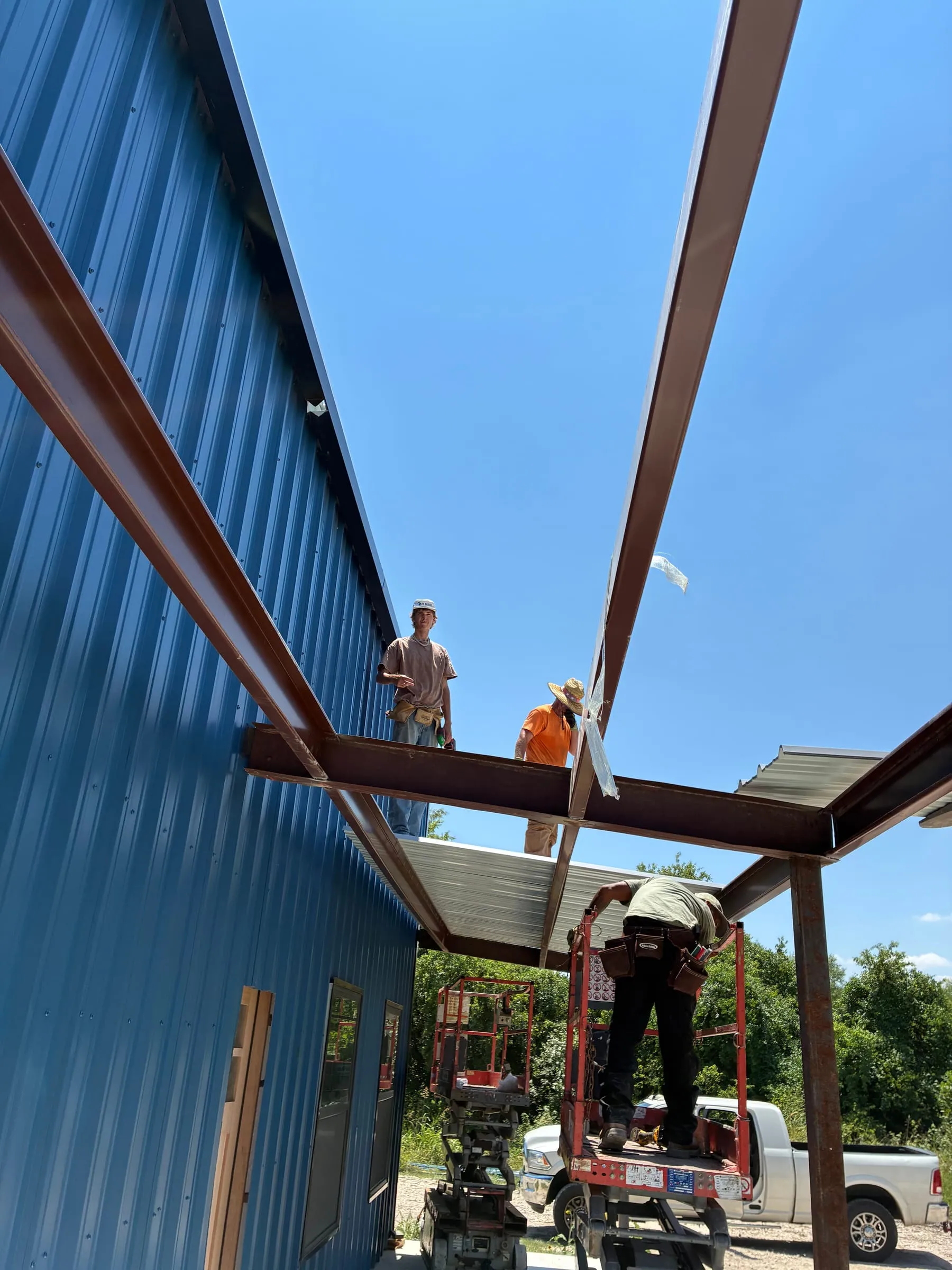 Crew installs the steel frame for the covered front patio.