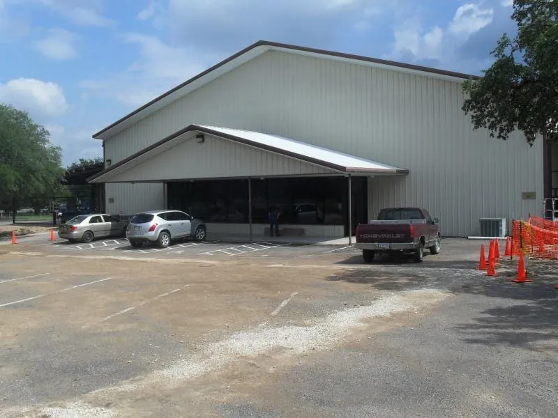New Covenant Church building with metal roof and covered entry.